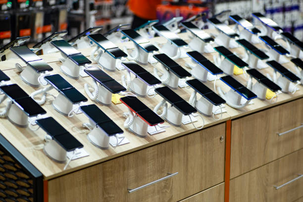 A display table filled with various budget smartphones showcased in a store.