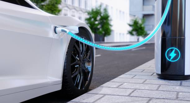 A white electric vehicle charging at a modern charging station on an urban street.