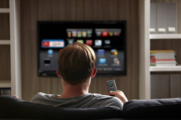 User browsing internet on Smart TV, a feature absent in regular television sets